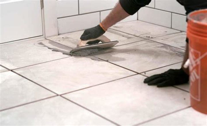 Can I use grout to adhere tile?