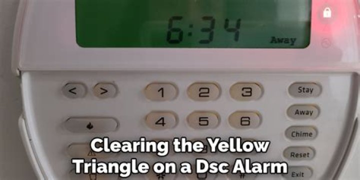 How do I get rid of the yellow triangle on my DSC alarm?