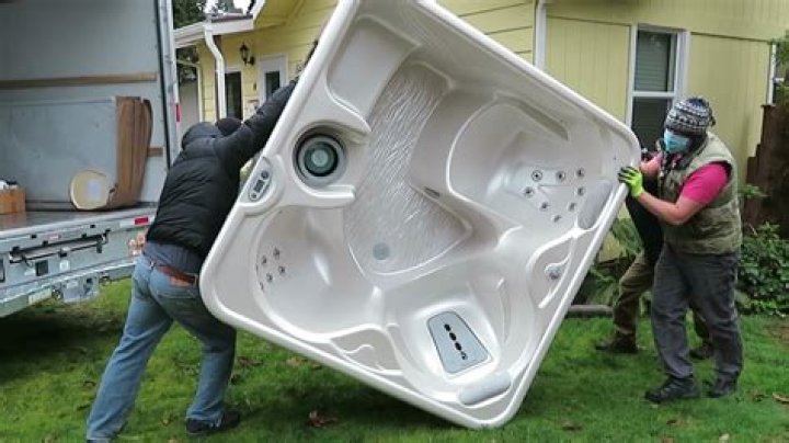 How do you lift a hot tub on its side?
