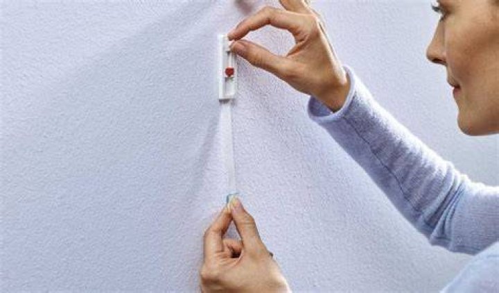 How do you stick on walls without damaging paint?