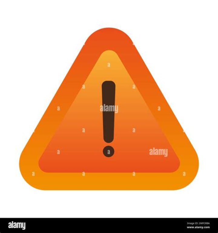 What does the orange triangle with an exclamation point mean in a car?