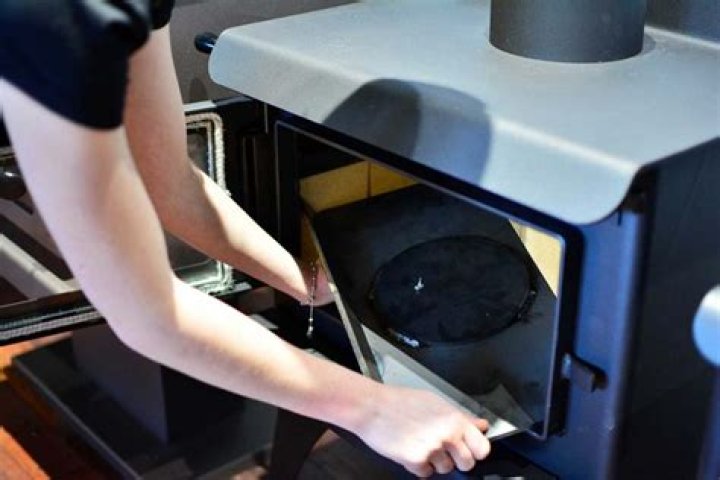 What is a baffle plate in a wood burning stove?