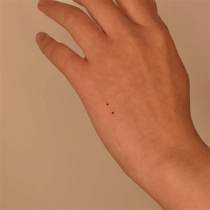 What is the meaning of 2 dots tattoo?