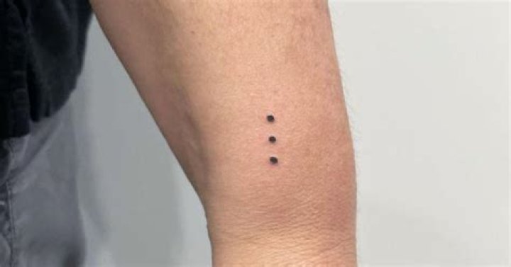 What is the meaning of the dot tattoo?