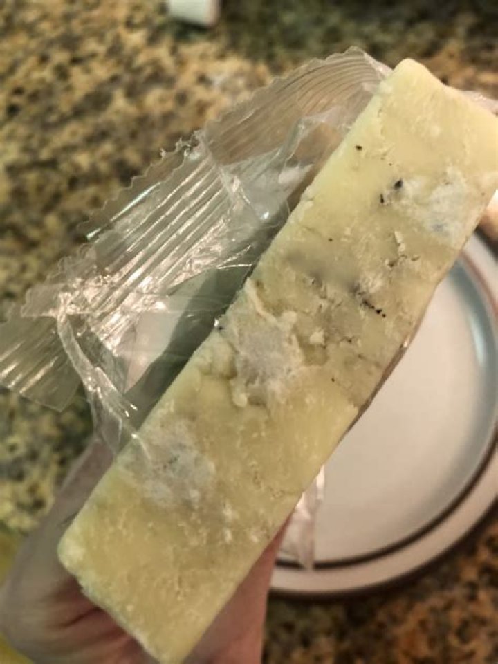 What is the white powder on shredded cheese?