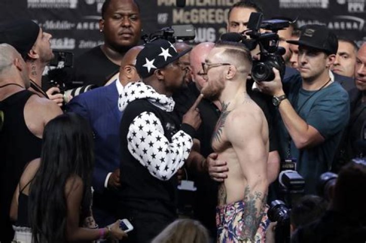 What size gloves did Mayweather and McGregor use?