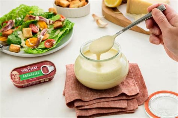 Why do they put anchovies in Caesar dressing?