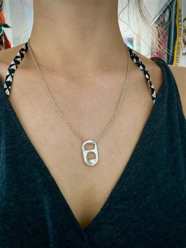 Why does Sarah Cameron wear a can tab necklace?